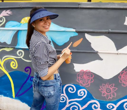 Renowned Filipino Artist paints 100 feet long wall